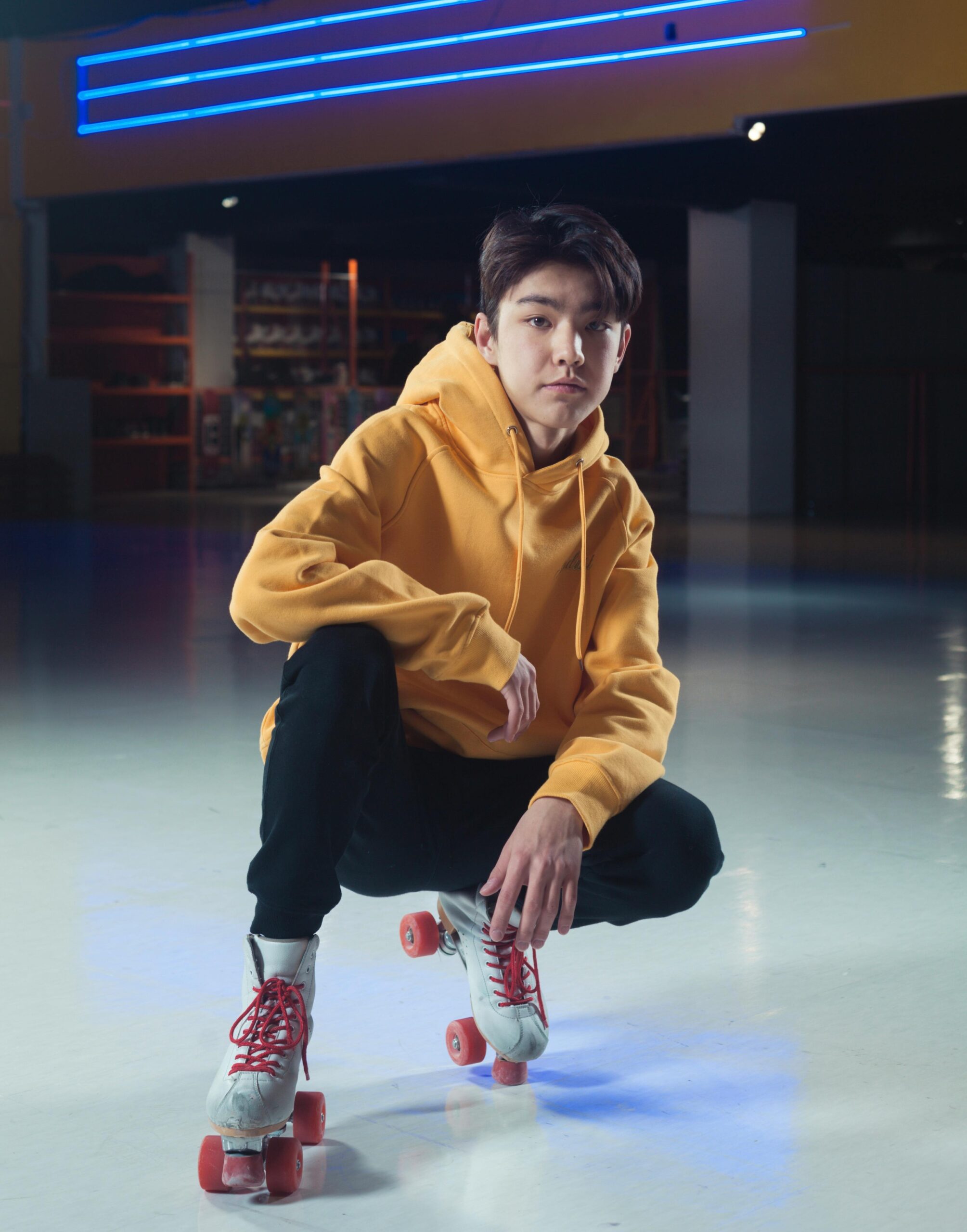 Young Teen Male in a Skating Rink wearing old school quad skates